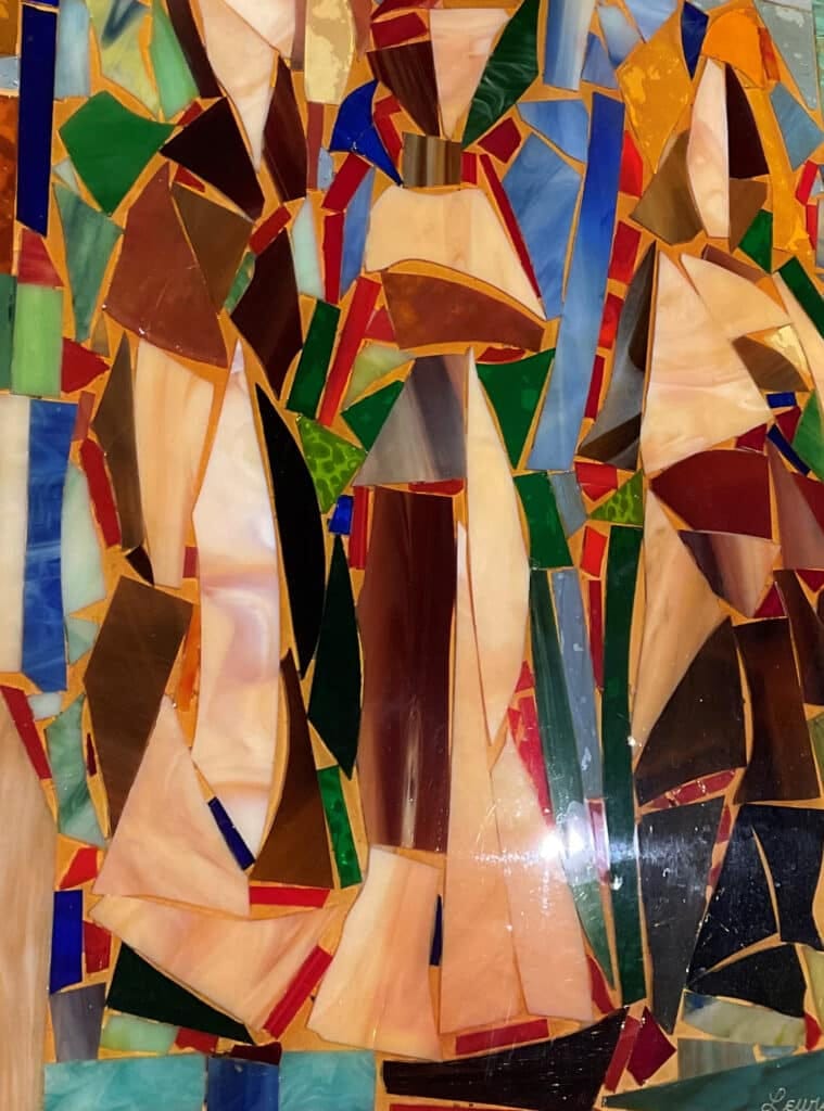 A work of art that displays sharply angular pieces of brown, red, and blue glass.