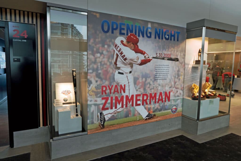 A larger-than-life size photo of baseball player Ryan Zimmerman swinging a bat.