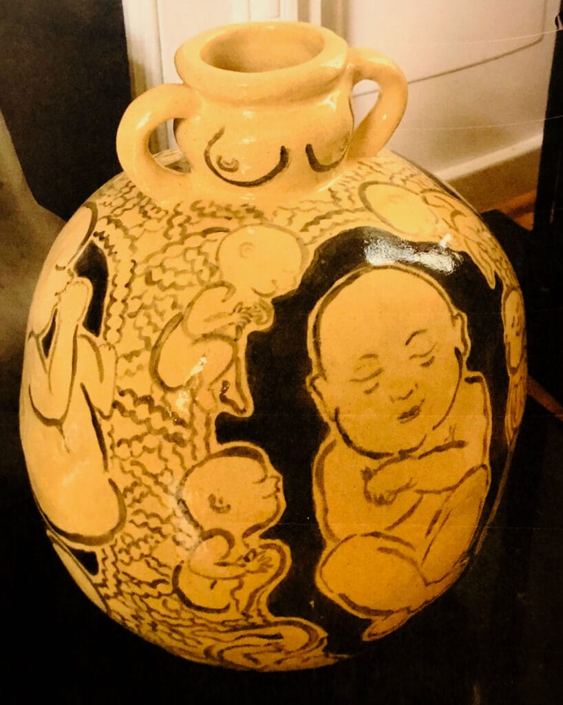 A vase that has a fetus on it.