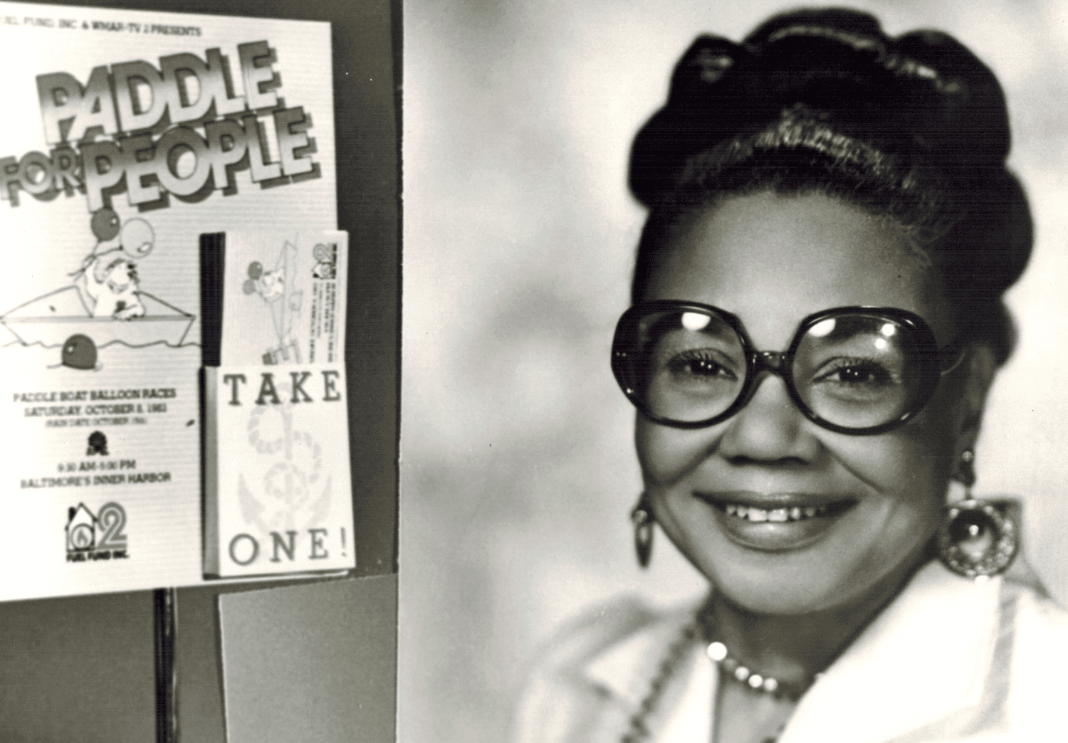 A 1960s photo of a woman with her hair pulled back and wearing large round eyeglasses.