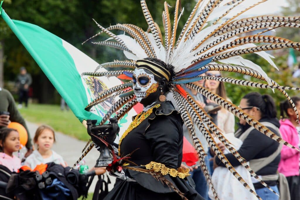 A woman wears traditional clothing representing ancestors for a Day of the Dead celebration.