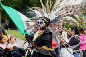 A woman wears traditional clothing representing ancestors for a Day of the Dead celebration.