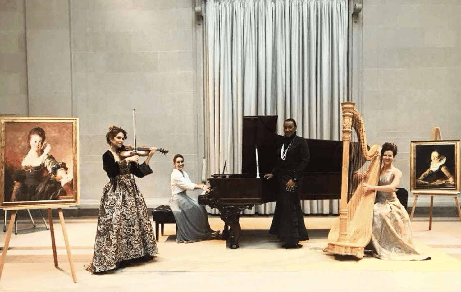 A group of women play instruments on a stage.