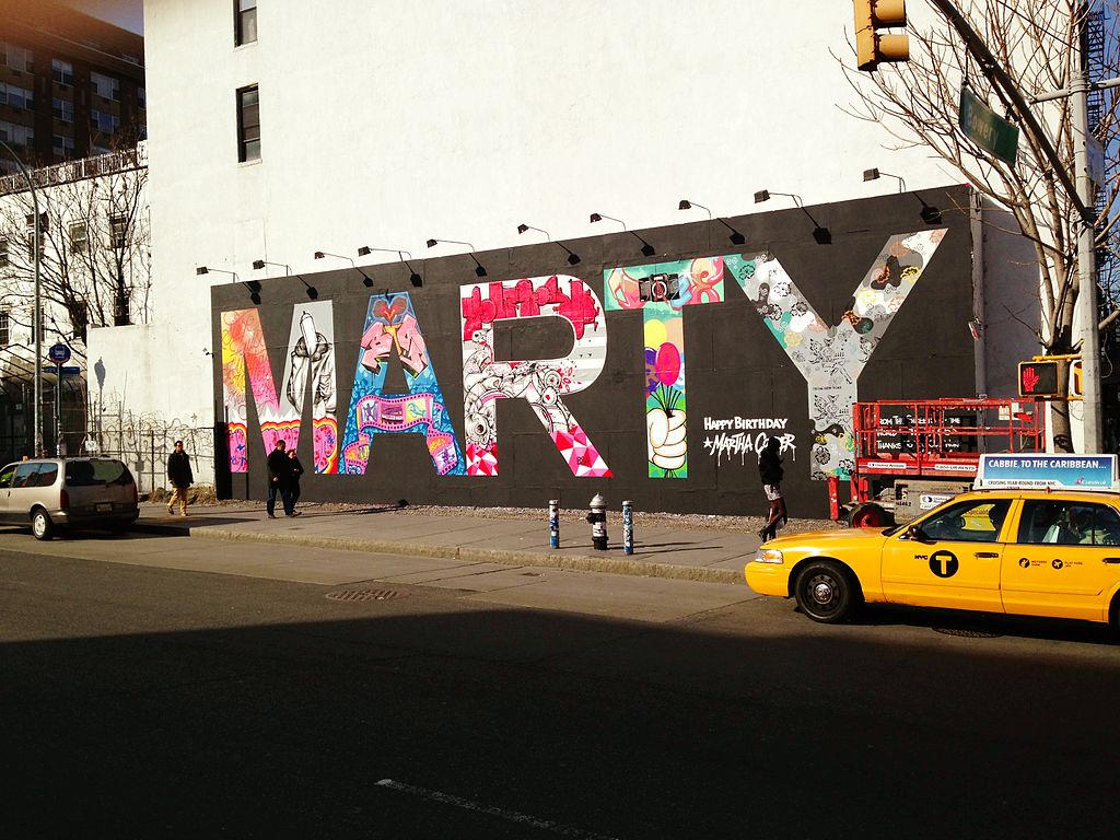 A wall in an urban setting that is covered with the word, Marty, drawn in grafitti art.