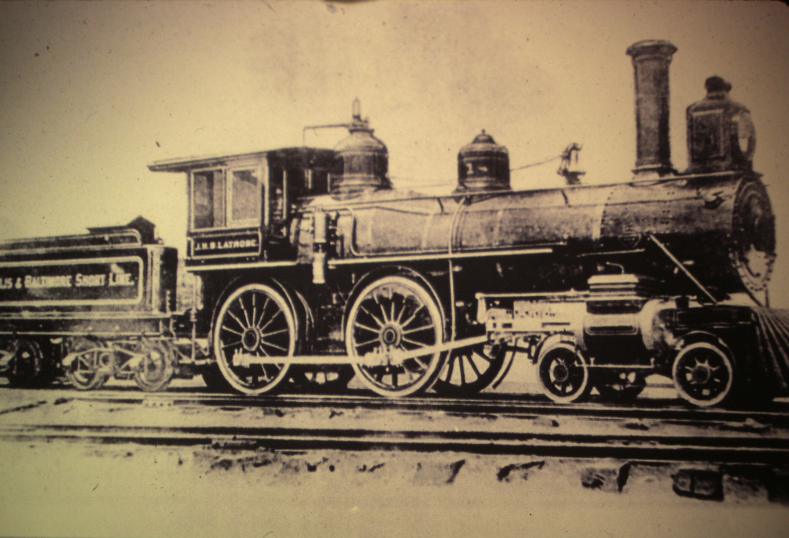 Sepia-toned vintage image of a Baltimore & Ohio Steam Engine on a track.