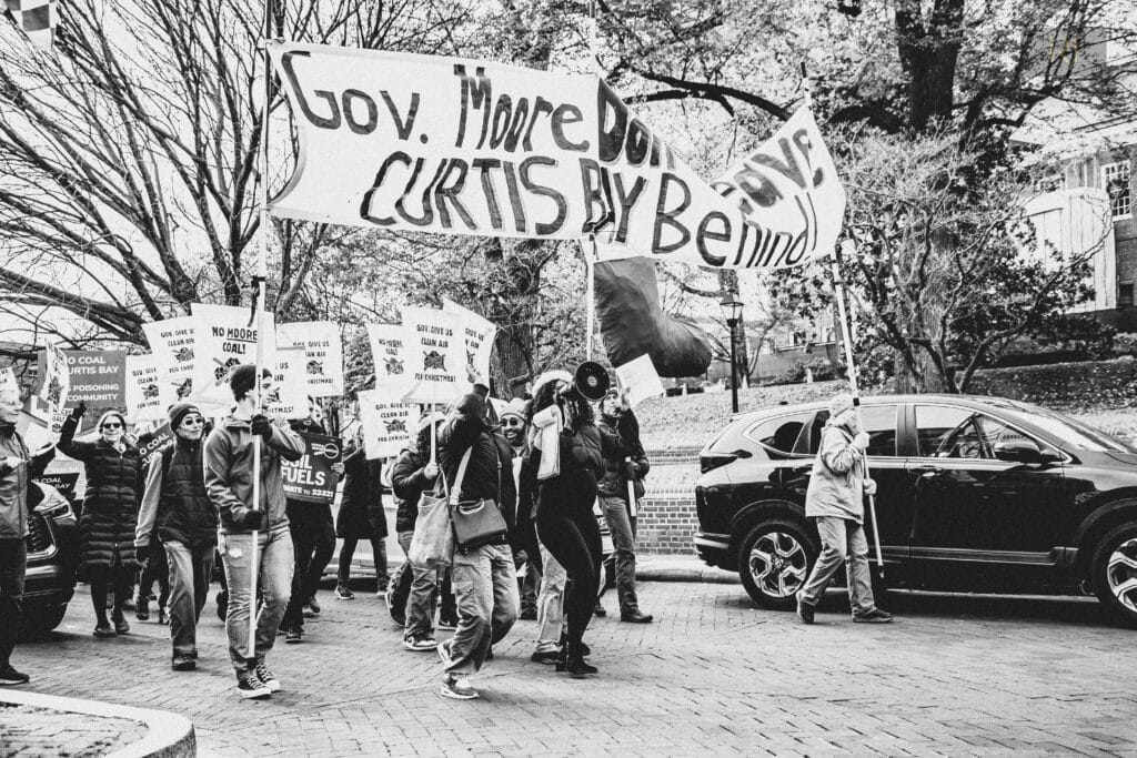 People protest for environmental justice on a city street. Photo by Ryan Johnson.